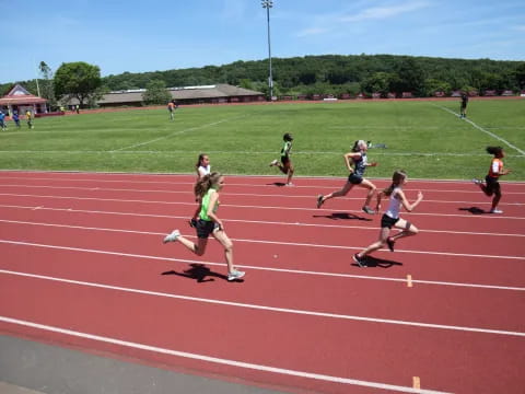 a group of people running on a track