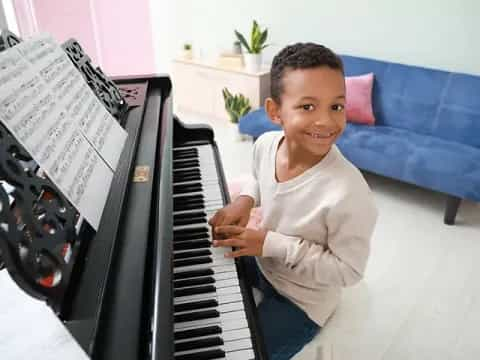 a boy playing a piano