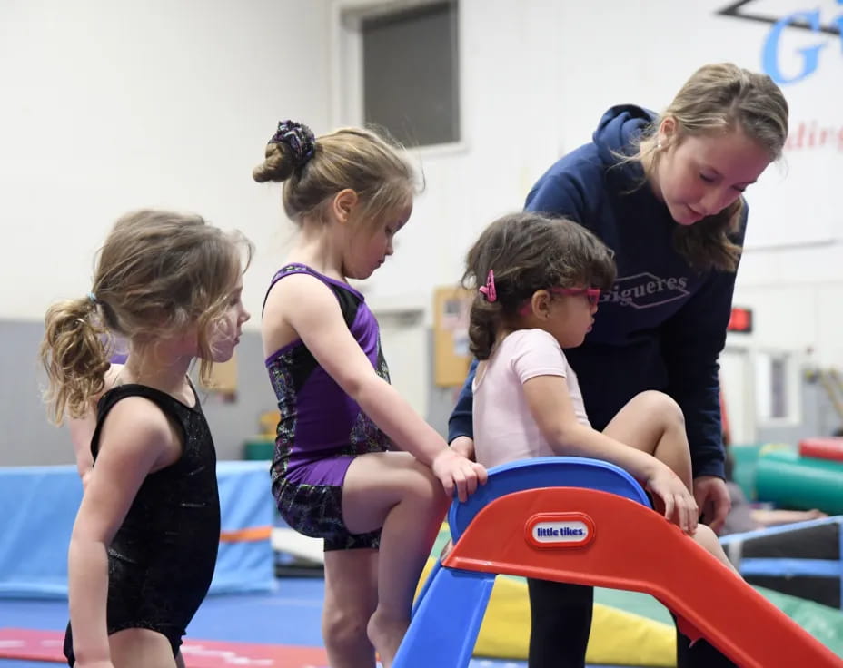 a group of girls playing on a trampoline