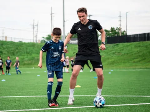 a man and a boy playing football