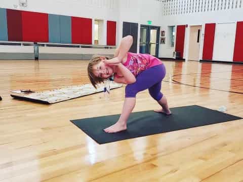 a person doing yoga in a gym
