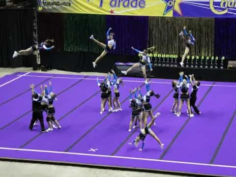 a group of women performing on a purple mat