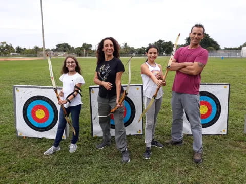 a group of people holding arrows