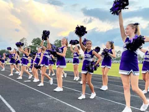 a group of cheerleaders on a track