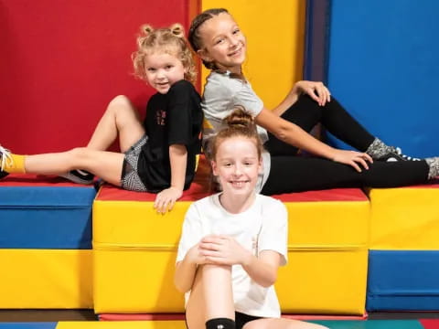 a group of children on a yellow mat
