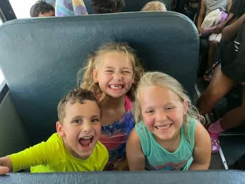 a group of children sitting in a chair