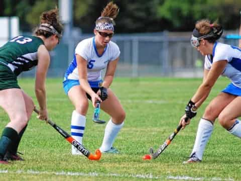 women playing field hockey