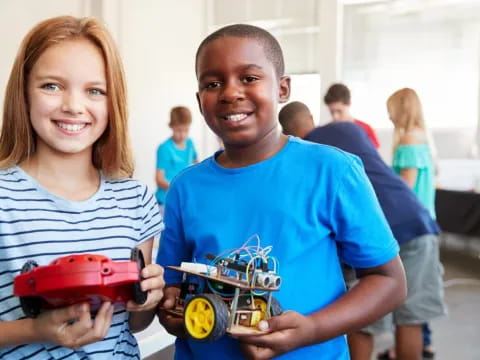 a boy and girl holding toy cars