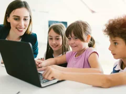 a group of people looking at a laptop