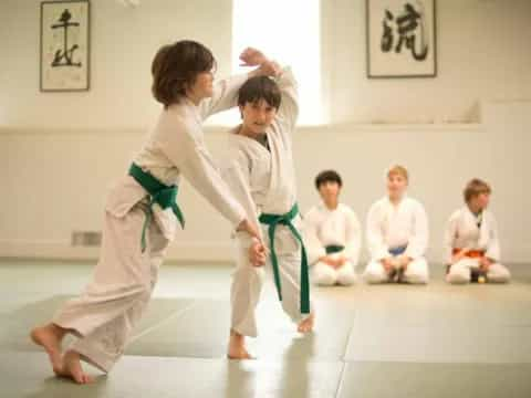 a group of people in karate uniforms