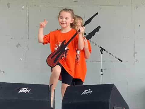 a girl holding a guitar