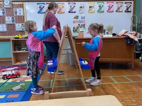 a group of children playing on a wooden structure in a classroom