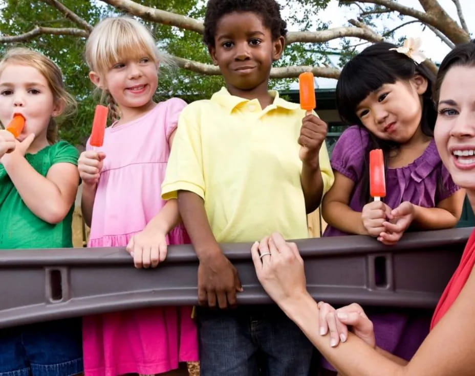 a group of children holding toothbrushes