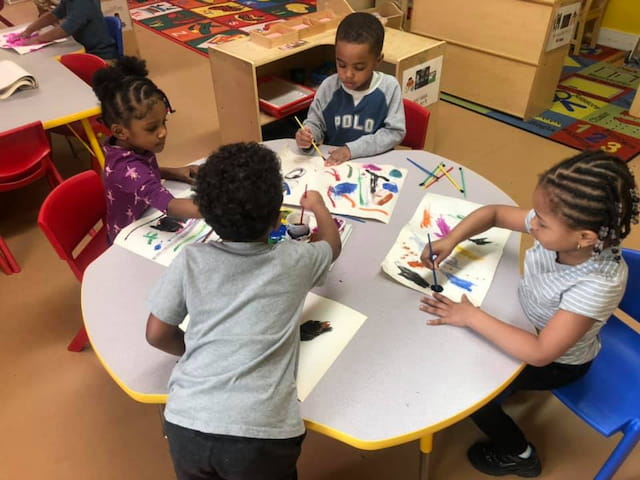 a group of children sitting at a table