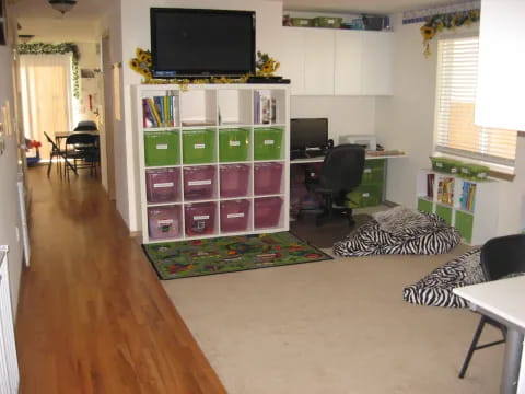 a room with a tv and shelves