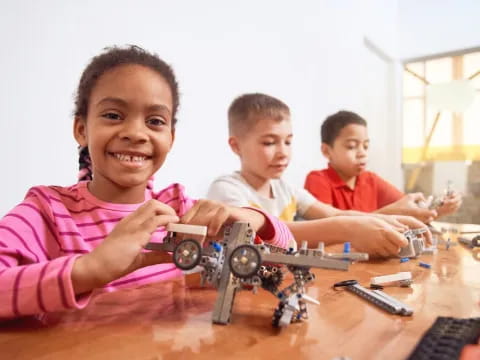 a group of children playing with toy cars