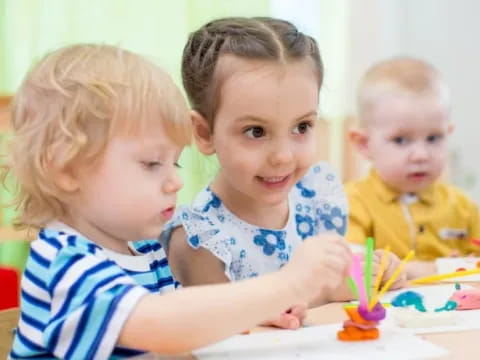 a group of children sitting at a table