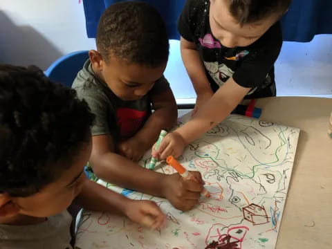 a group of children playing with a puzzle