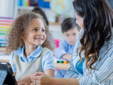 a person and a child looking at a tablet