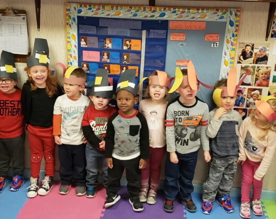 a group of children wearing party hats