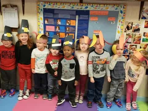a group of children wearing party hats