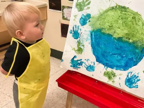 a child painting on a canvas