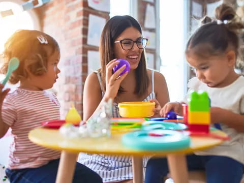 a person and kids eating at a table