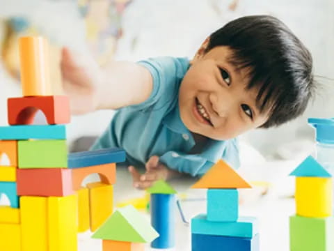 a child lying on a pile of blocks