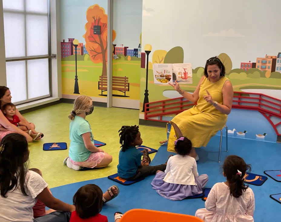 a woman teaching children in a classroom