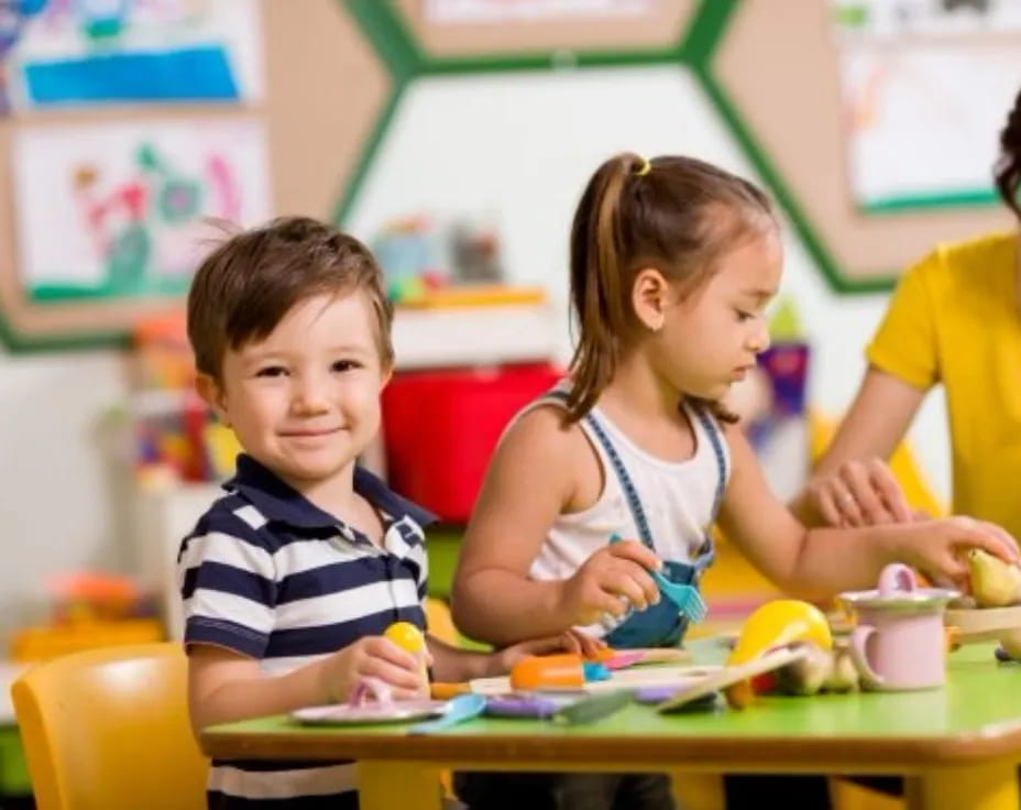 a few children sitting at a table