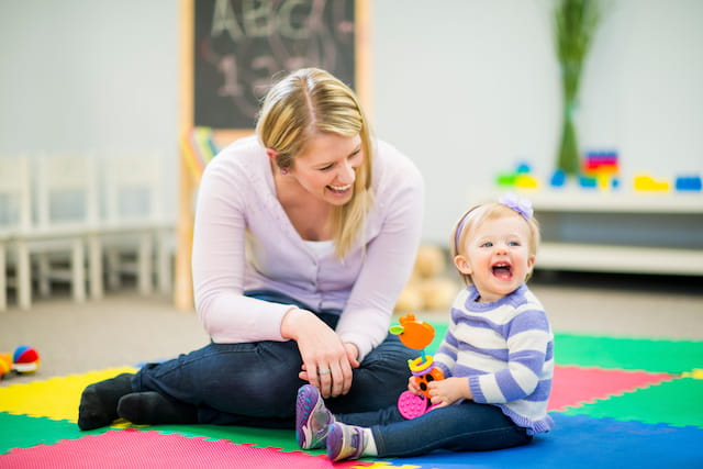 a woman and a child sitting on the floor