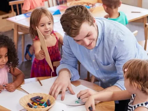 a person and children sitting at a table