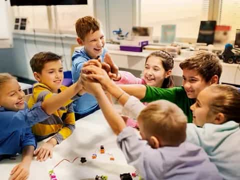 a group of children sitting around a table