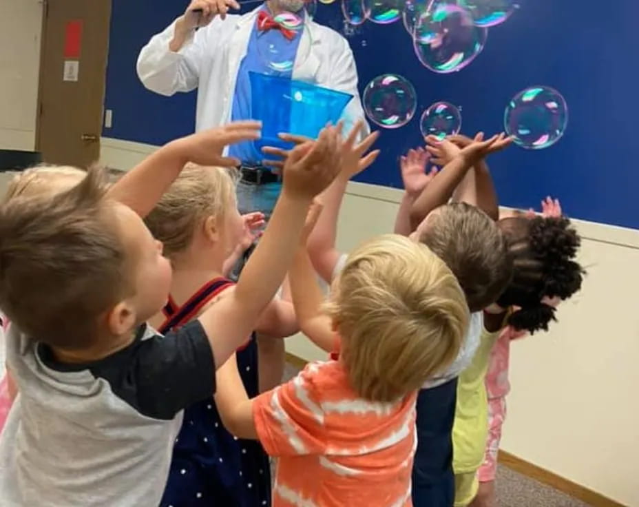 a group of children playing with bubbles