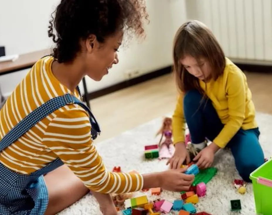 a person and a child playing with toys