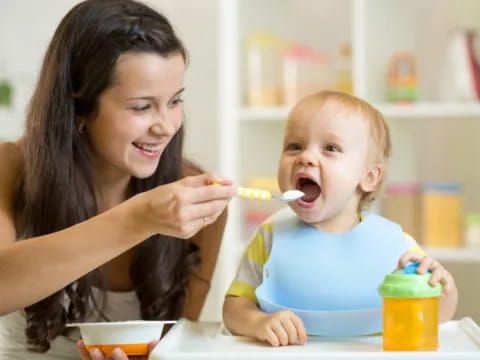 a person brushing a baby's teeth