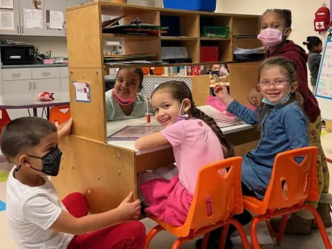 a group of children sitting at a table