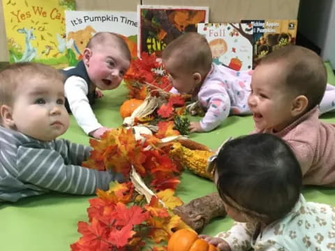 a group of children sitting on the floor with a pile of toys