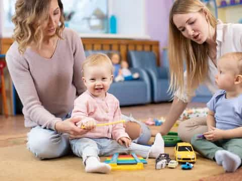 a person and two children playing with toys