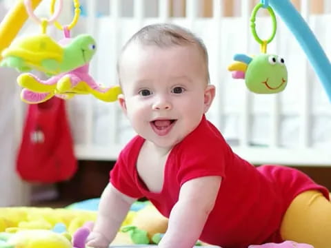 a baby in a red shirt