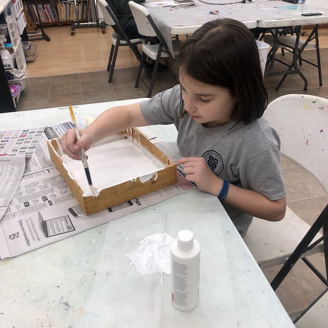 a person painting on a table