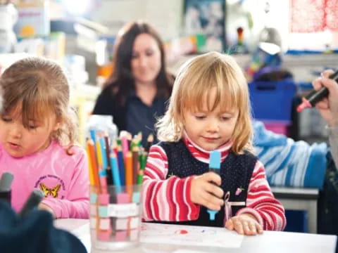 a few children sitting at a table