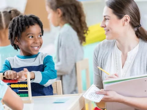 a teacher showing her student something on the tablet