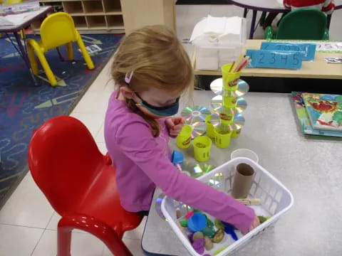 a girl painting on a table