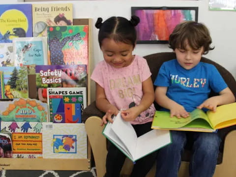 a boy and girl reading a book