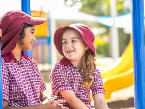 a couple of children playing on a playground