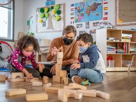 a group of people playing with blocks