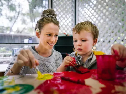 a person and a boy sitting at a table