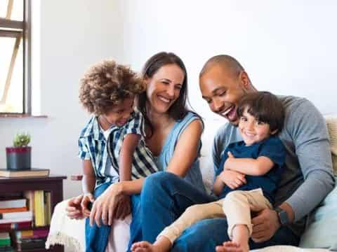 a family sitting on a couch