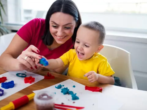 a person and a child playing with toys